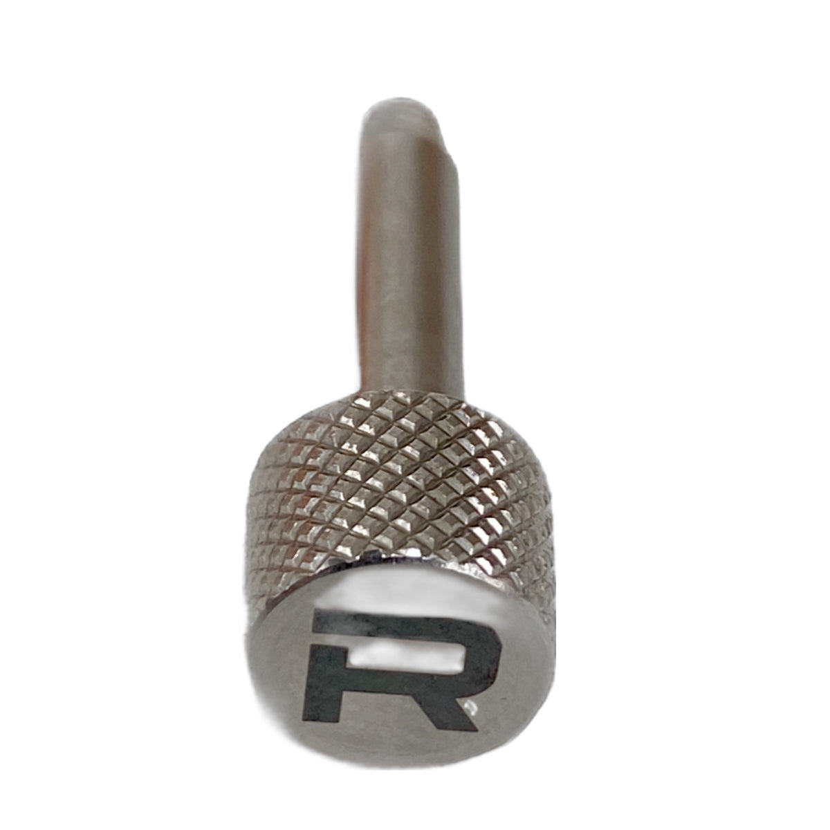 A close-up of the RapidArm+ Ball Thrower by RapidArm, featuring a metallic knurled grip and an engraved "R" on the end, photographed against a white background.