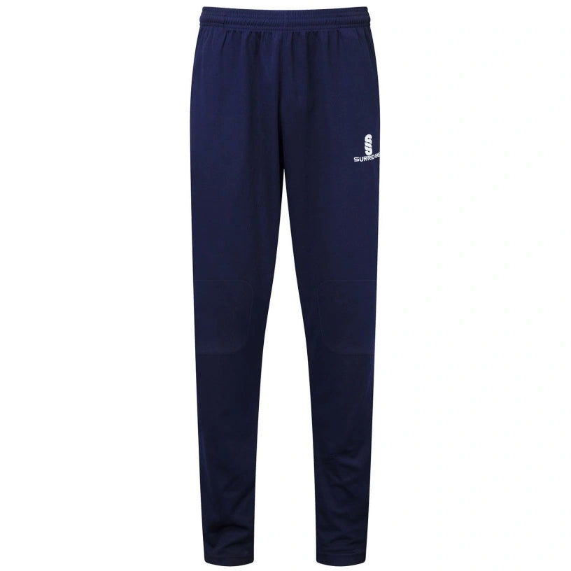 The Surridge Blade Coloured Playing Trouser in navy features an elastic waistband, knee reinforcement for durability, and a small white Surridge logo on the left thigh, shown against a white background.