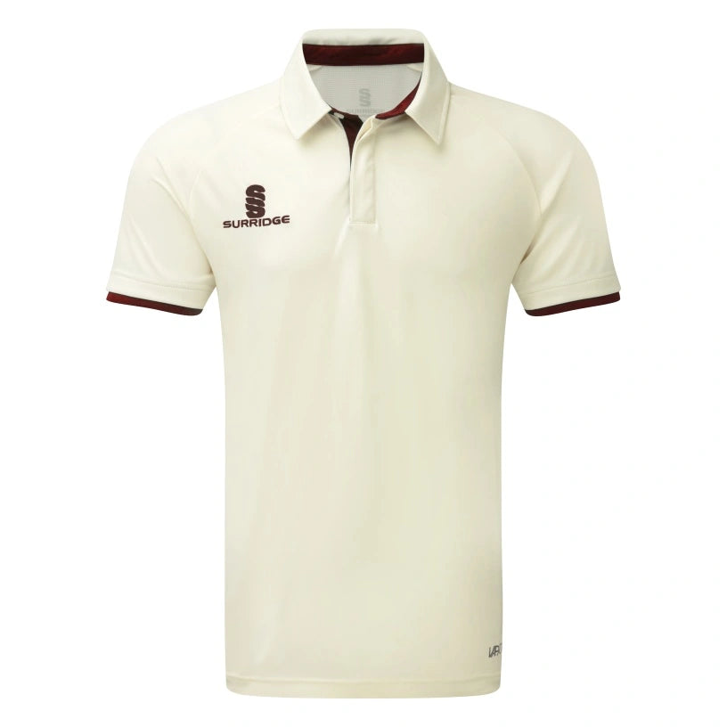 The Surridge Ergo Short Sleeve Playing Shirt is a maroon cricket polo featuring a collar, short sleeves, VAPADRI technology for comfort, and the “Surridge” logo and text on the left chest.