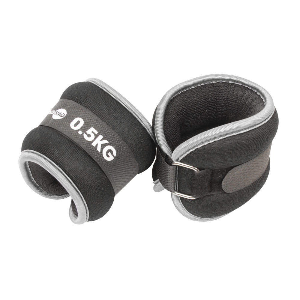 The Fitness Mad Wrist/Ankle Weights by Fitness Mad are black and gray neoprene weights (0.5KG each) with Velcro straps and metal D-rings, ideal for adding resistance to aerobic workouts.