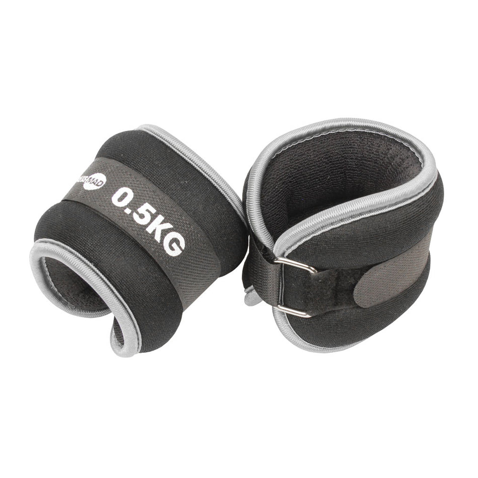 The Fitness Mad Wrist/Ankle Weights by Fitness Mad are black and gray neoprene weights (0.5KG each) with Velcro straps and metal D-rings, ideal for adding resistance to aerobic workouts.