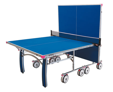 The Butterfly Garden Rollaway 5000 5mm Outdoor Table Tennis Table by Butterfly is blue, foldable with wheels for transport, has a 5mm melamine surface, upright half for solo play, and comes with a black net.