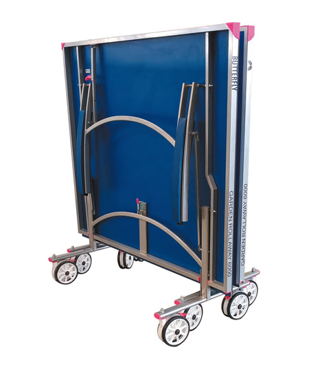 The Butterfly Garden Rollaway 6000 6mm Outdoor Table Tennis Table by Butterfly is shown upright on four sets of wheels for easy storage or transport, featuring a metal frame, 6mm melamine top, and pink corner accents.