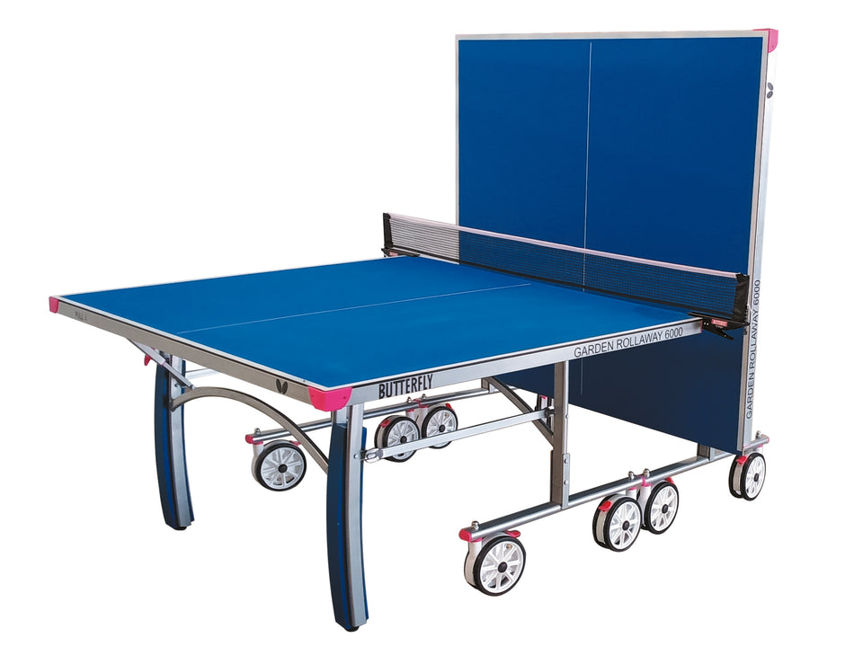 The Butterfly Garden Rollaway 6000 6mm Outdoor Table Tennis Table by Butterfly is shown partially folded for solo practice, with a sturdy metal frame, net, and wheels for easy transport.