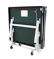 The Butterfly Centrefold 25 Rollaway Table Tennis Table by Butterfly, shown folded from the back, features white metal legs, anti-skid wheels, and a space saver system for easy storage or transport.