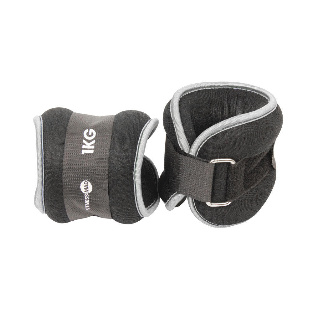 Fitness Mad Wrist/Ankle Weights by Fitness Mad feature black and gray neoprene, Velcro straps, and metal loops—ideal for fitness and strength training. Branded with the Fitness Mad logo, they’re perfect for aerobic workouts.