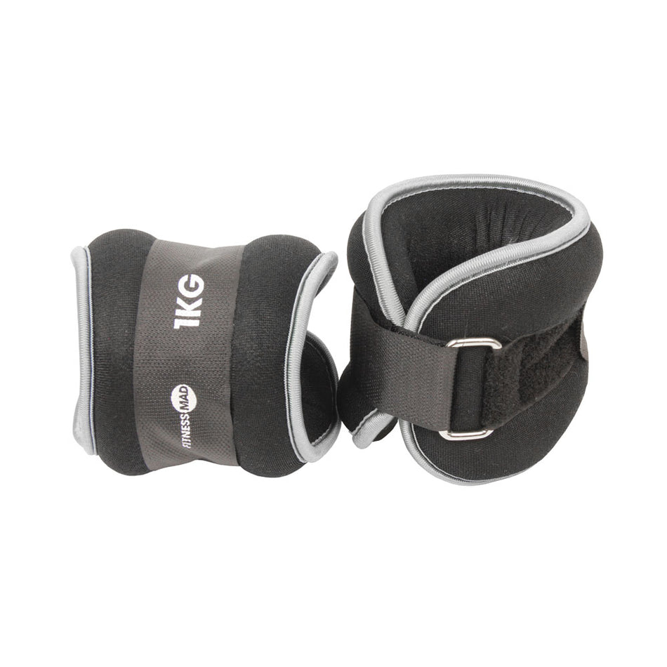 Fitness Mad Wrist/Ankle Weights by Fitness Mad feature black and gray neoprene, Velcro straps, and metal loops—ideal for fitness and strength training. Branded with the Fitness Mad logo, they’re perfect for aerobic workouts.