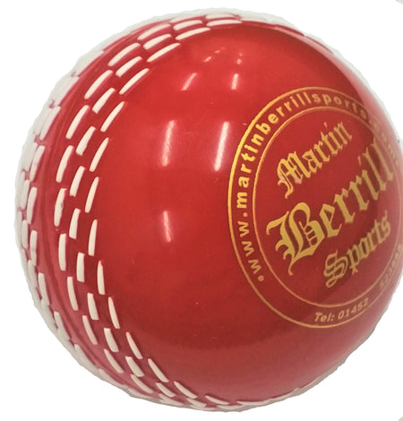 The Storm PVC Coaching & Training Ball by Martin Berrill Sports is a red ball with white stitching and a gold logo, ideal for Kwik Cricket and training sessions.