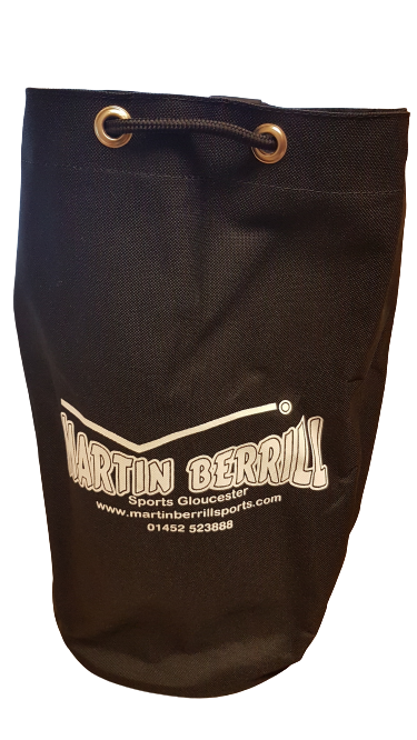 The Ball Duffle Bag by Martin Berrill Sports is a black drawstring bag with metal eyelets for sports ball storage, featuring the brand's logo and contact info printed in white on the front.