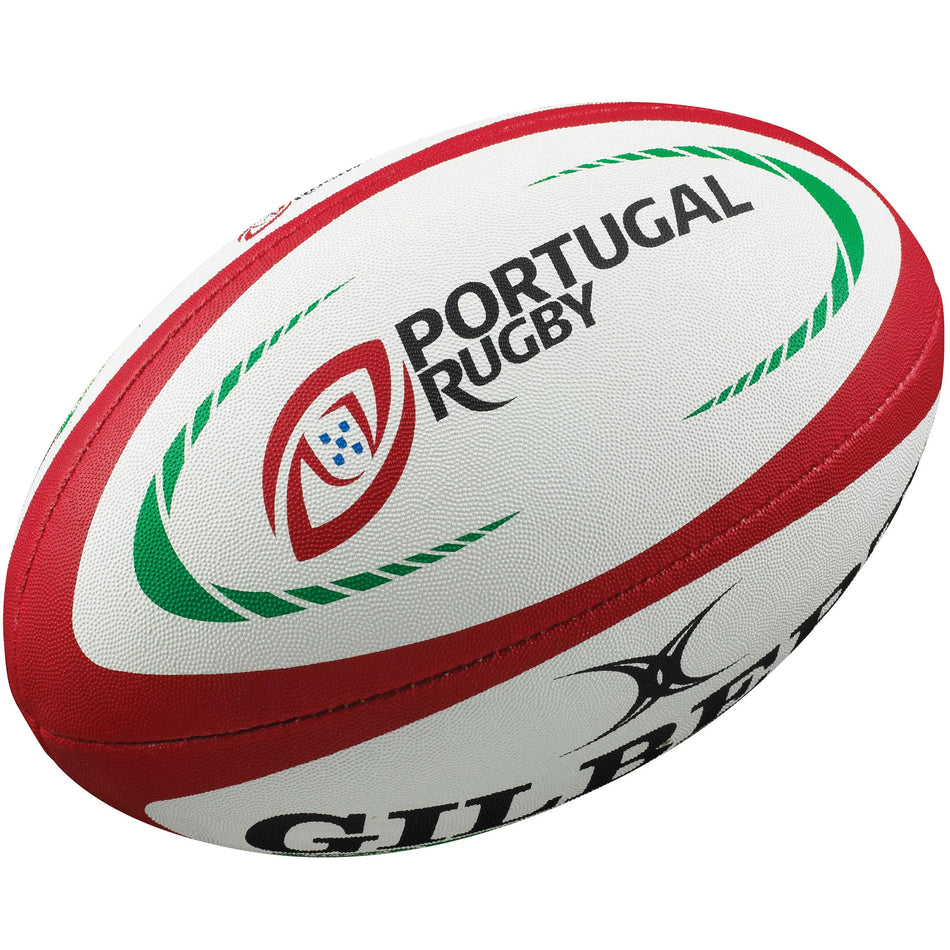 The Gilbert Portugal Replica Rugby Ball is a white rugby ball with red and green accents, featuring "Portugal Rugby" text, a shield logo, and the Gilbert brand name printed on the side.