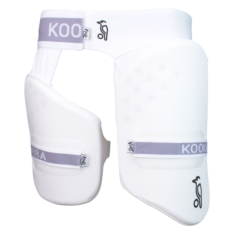 The Kookaburra Pro Guard 250 by Kookaburra is a white thigh guard with grey straps and a black kangaroo logo, featuring a main pad and attached side piece for club level cricket protection.