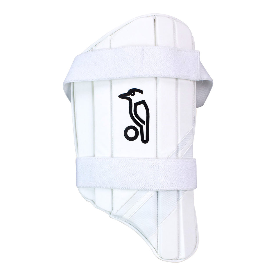 The Kookaburra Pro Thigh Pad from Kookaburra is a white pad with a Multi Flex Design, vertical padding lines, two adjustable white straps for Comfort Fit, and features the black Kookaburra bird logo with a ball in the center.