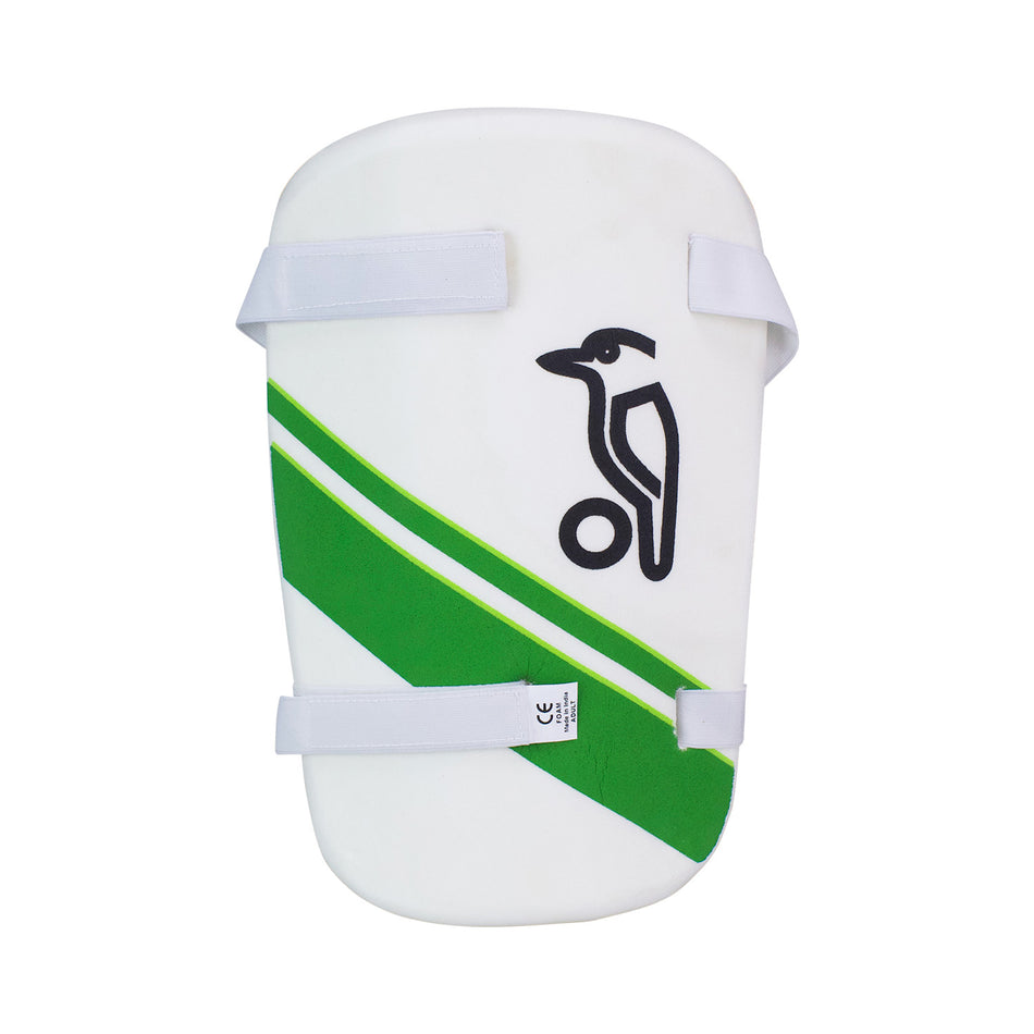The Kookaburra 500 Thigh Pad is a white cricket thigh guard with moulded HDF for impact protection, green diagonal stripes, two adjustable white straps, towel backing, and features the Kookaburra bird logo above a small ball on the front.