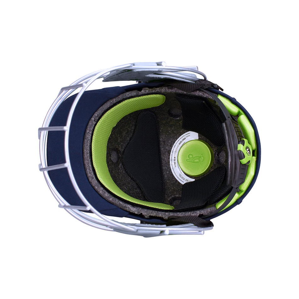 Top-down view of the Kookaburra Pro 1200 Senior Helmet, displaying green padding, black cushioning, lightweight ABS shell, grey finish, metal face guard, adjustment dial, and safety foam. Brand: Kookaburra.