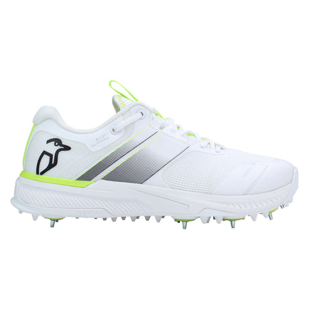 The Kookaburra KC Players Spike by Kookaburra is a white athletic shoe with light green accents, metal spikes on the sole, a breathable lightweight insole, and a black penguin logo on the heel.