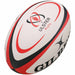 The Gilbert Ulster Replica Rugby Ball by Gilbert features striking white, red, and black curved accents with the Ulster Rugby logo—perfect memorabilia for any Irish rugby fan.