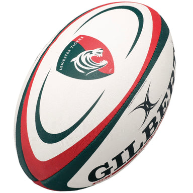 The Gilbert Leicester Tigers Replica Rugby Ball is a white ball with red and green curved stripes, featuring the Leicester Tigers logo and bold Gilbert branding—perfect for Gallagher Premiership Rugby fans.