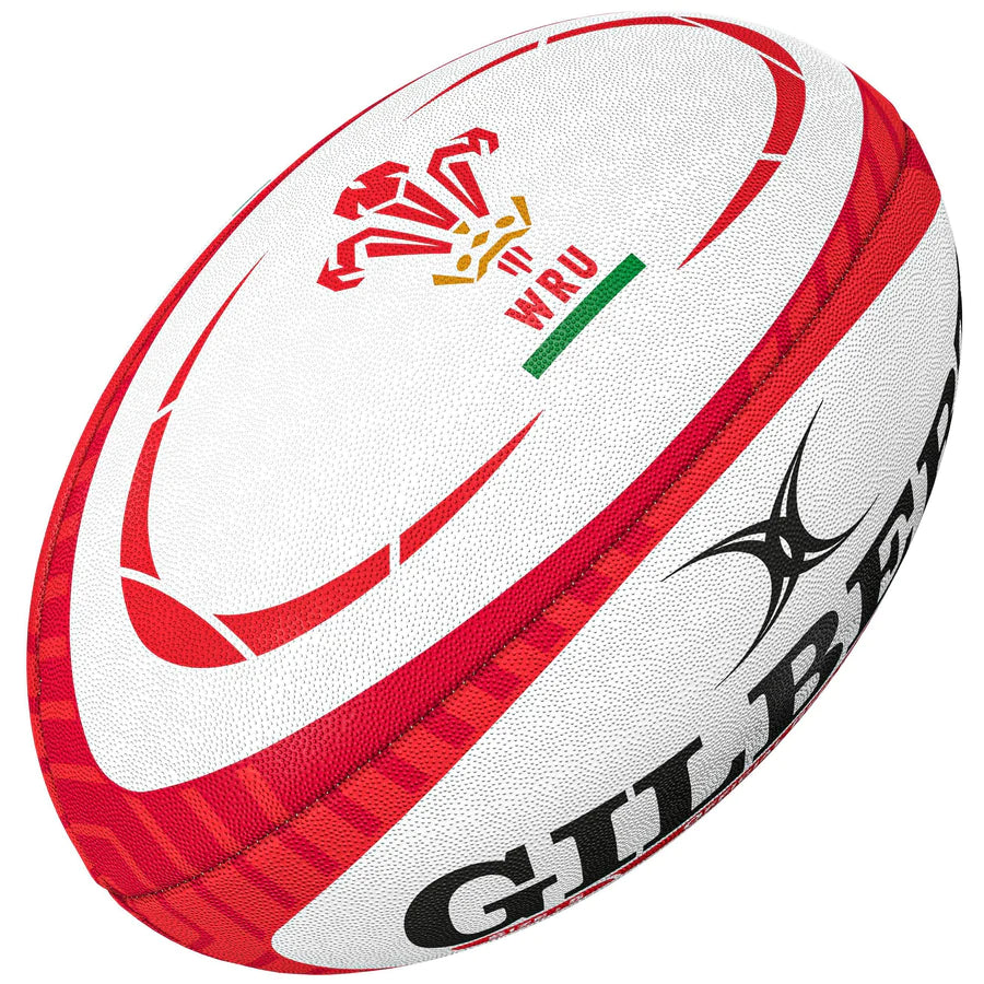 The Gilbert Wales Replica Rugby Ball features a white and red design with the WRU logo, partial Gilbert branding, and textured panels—ideal for Rugby World Cup 2023 fans.