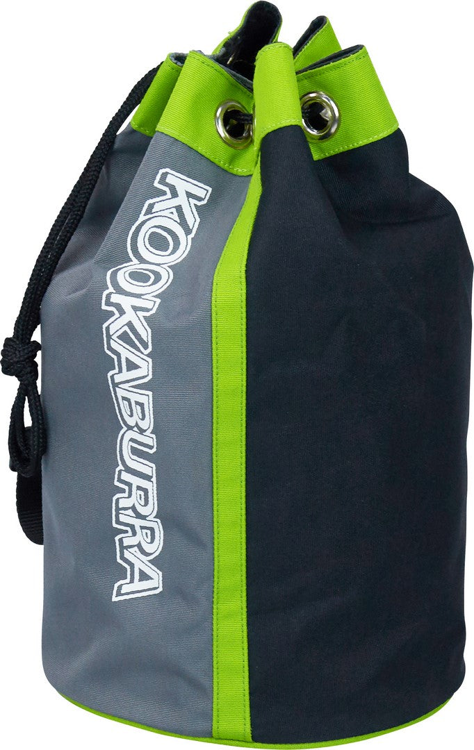 The Kookaburra KT 100 Training Bag is a cylindrical net practice bag made from braided 600D material, featuring black, gray, and neon green design, drawstring closure with metal eyelets, adjustable shoulder strap, and KOOKABURRA branding.