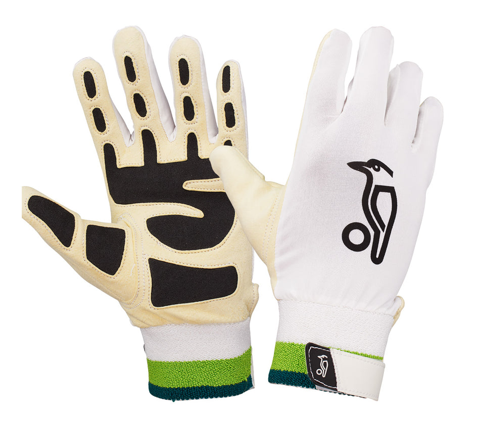 A pair of ergonomic Kookaburra Ultimate Wicket Keeping Inners—white with green-striped wristbands—feature memory foam, a chamois palm with black grip, and a bird logo on the back. Brand: Kookaburra.