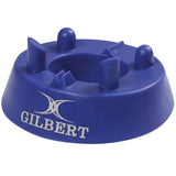 The Gilbert 320 Precision Kicking Tee is a blue moulded rubber tee with raised supports to hold a rugby ball upright. The white GILBERT logo and name are printed on the side.