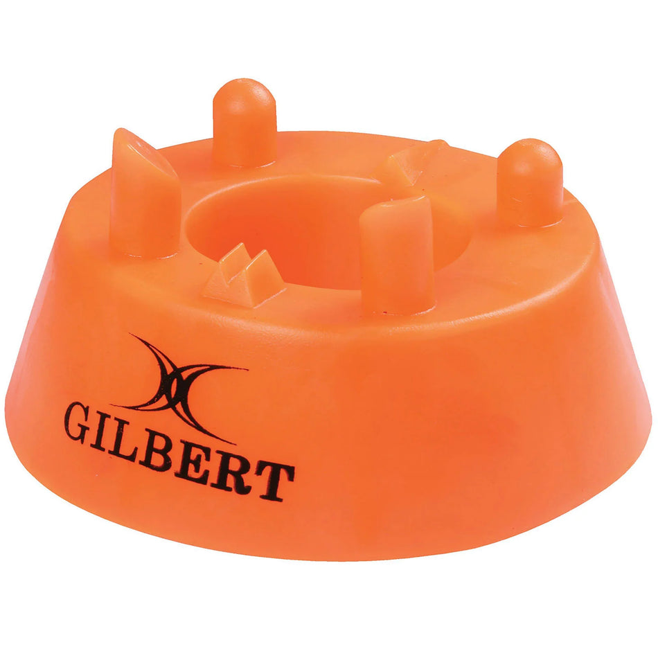 The Gilbert 450 Precision Kicking Tee is an orange kicking tee with four prongs and a black Gilbert logo, designed for rugby players seeking professional-level accuracy.