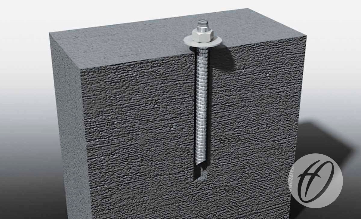 A Harrod Sport Chem Bolt Anchor with washer and nut is vertically installed in a gray concrete block, partially embedded for secure ground fixing, with the Harrod Sport logo displayed in the lower right corner.