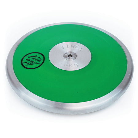 A green and silver steel rim Club Discus by Mastersport, featuring a metallic center and warning label on the left side. Weighs 5 KG, ideal for track and field events at schools or clubs.