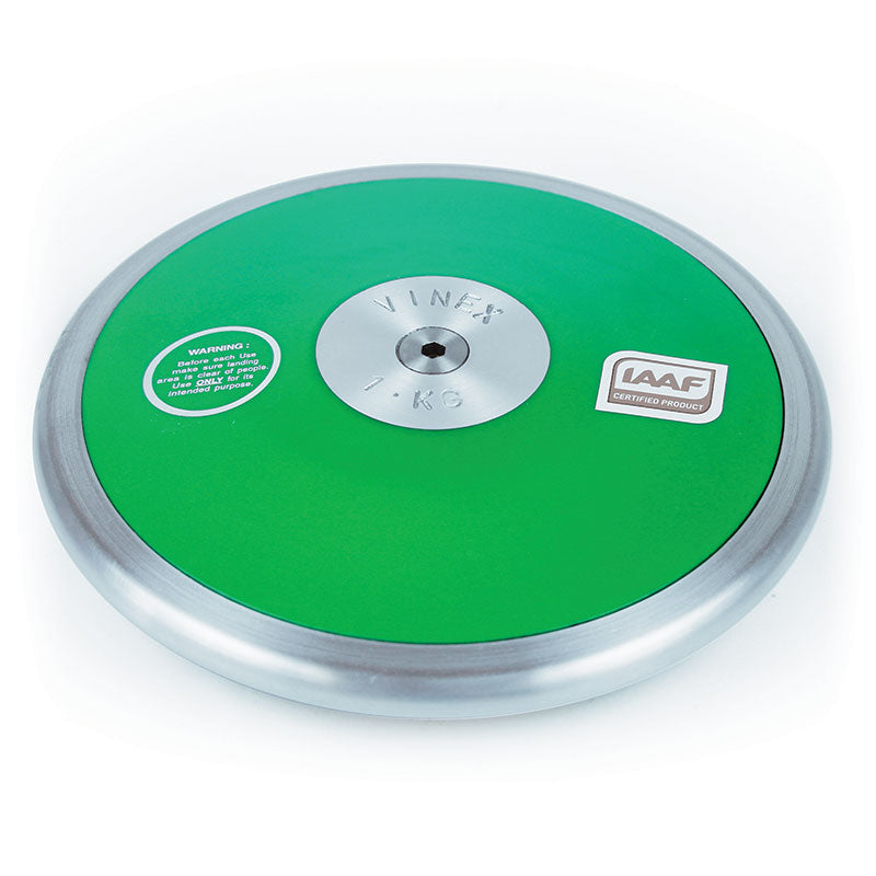 The Mastersport Club Discus is a green and silver steel rim discus with a 1 KG central metal plate, warning and certification labels, designed for athletic throwing events.