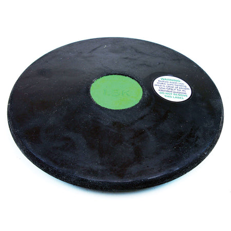 The Mastersport Rubber Training Discus features a black rubber body, green center marked "1.5K," and white warning sticker. Durable and reliable, it’s perfect for track and field practice sessions.