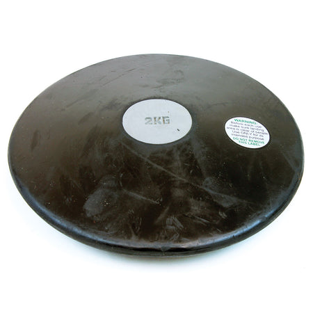 The Mastersport Rubber Training Discus, a durable black 2-kilogram disc with a silver center and warning label, is displayed against a white background.