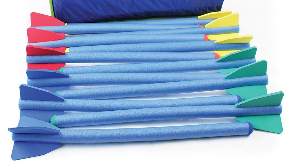 Twelve Mastersport Foam Javelins with blue bodies and colorful fins are displayed side by side on a white surface. A blue carry bag, included for easy transport, is partially visible at the top.