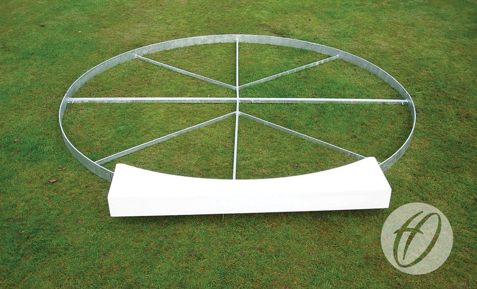 A large metal ring with cross braces lies on green grass beside a curved white Harrod Sport Shot Board. The Harrod Sport logo in the corner emphasizes quality athletics equipment.