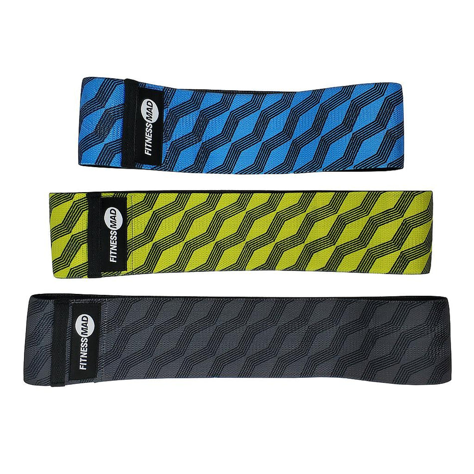 The Fitness Mad Squat Band Set of 3 includes blue, yellow, and black non-slip resistance bands with a zigzag pattern and branded label—perfect squat bands for your next glute workout.