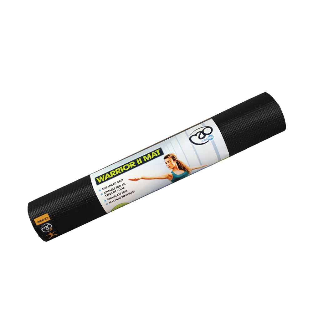 A rolled-up black Fitness Mad Yoga-Mad Warrior II Mat 4mm with a woman in a yoga pose on the packaging; its textured, phthalate-free surface offers improved grip, and product details are listed on the label.