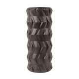 The Fitness Mad Tread Roller by Fitness Mad is a black foam roller with a textured geometric surface, ideal for myofascial release and deep tissue massage during physical therapy.
