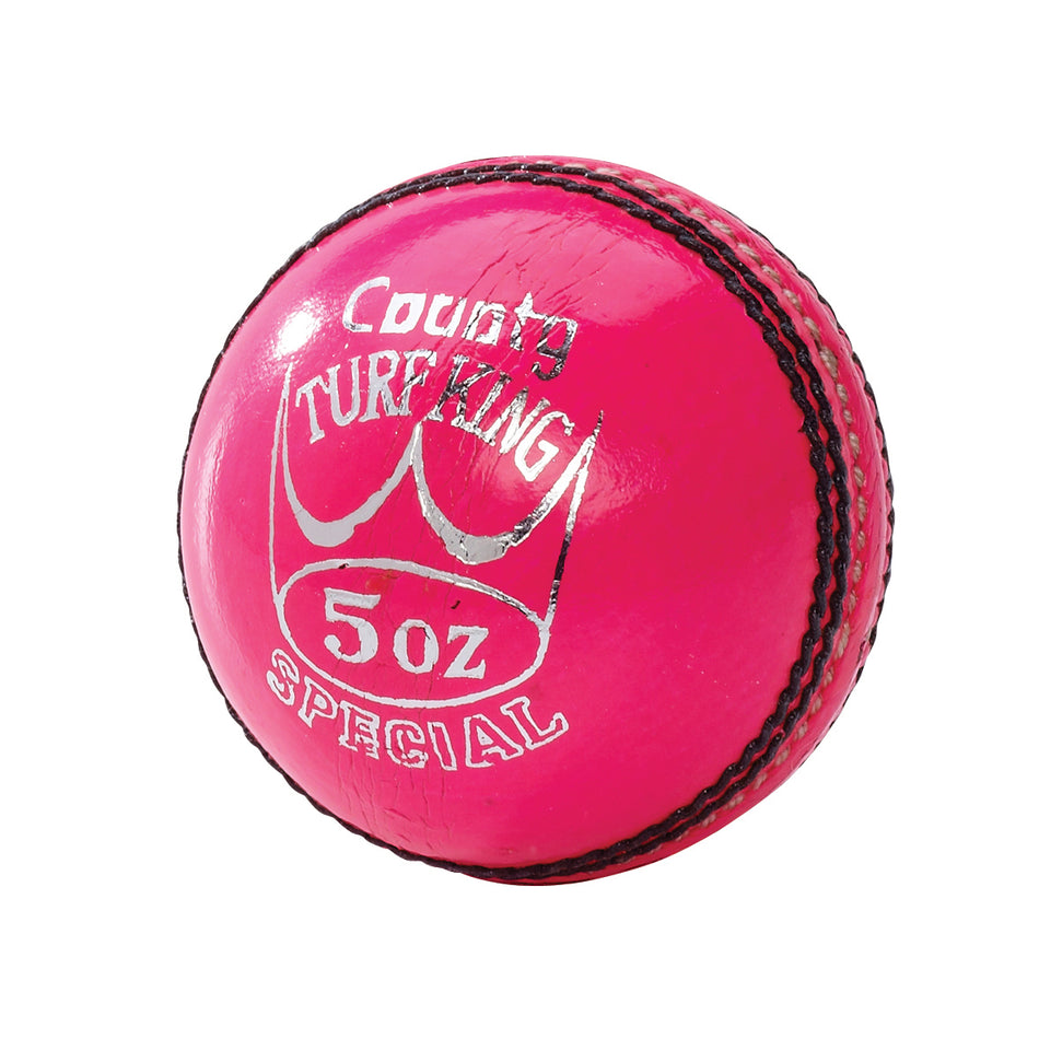 A shiny pink Hunts County Turf King Senior Match cricket ball with black stitching, silver "County Turf King Special 5 oz" text, and a crown graphic.