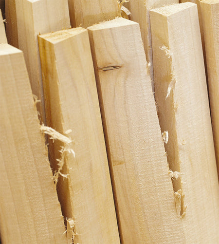Several unfinished English willow boards, with rough edges and visible grain, are ideal for crafting a Martin Berrill Sports Junior Custom Made Cricket Bat from premium Grade 1+ willow.