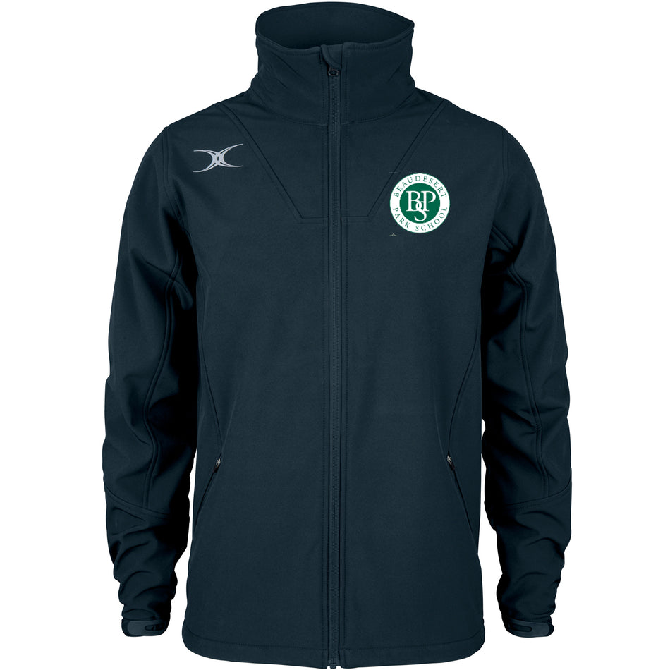 The Gilbert Beaudesert Park School Pro Soft Shell Full Zip Jacket is dark blue, water repellent, with a high collar and two front pockets. Features the school's circular green and white logo on the left chest and a white emblem on the right shoulder.