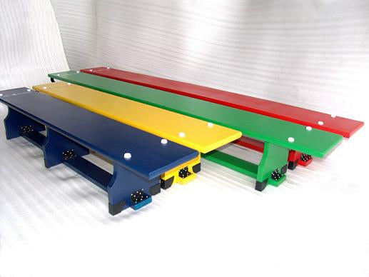 The Sure Shot Coloured Balance Bench (11ft) by Sure Shot is shown in red with white dots on its surface and black fittings at the ends, arranged side by side with other colorful benches on a white background.
