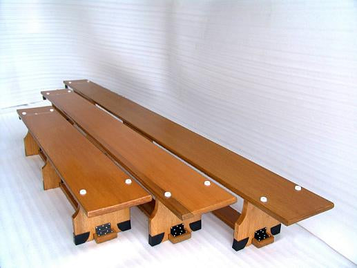 Three Sure Shot Balance Benches (11ft) by Sure Shot are arranged side by side on a white ridged surface, each featuring visible screws on top and black capped non-slip feet.