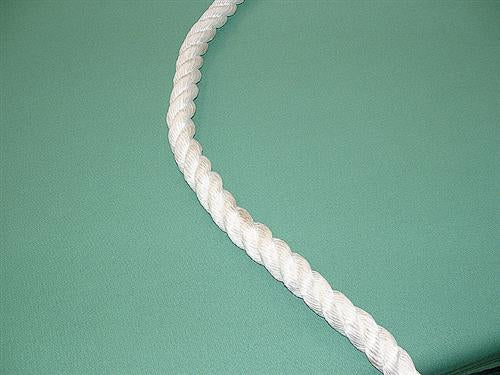 The Martin Berrill Sports 24mm Cricket Boundary Rope, thick and white, lies twisted diagonally along the smooth green edge of the cricket field.