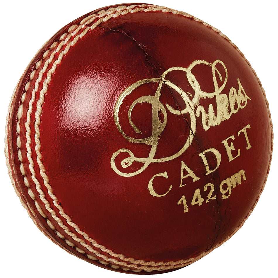 A shiny red Dukes Cadet A Cricket Ball (Junior) with premium leather, prominent white stitching, and gold text by Dukes.