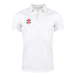 The Gray Nicolls Pro Performance V2 S/S Cricket Shirt is a slim fit white polo with short sleeves, a British collar, and a small red, black, and white rectangular logo on the left chest.