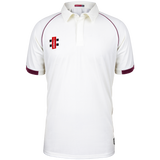 The Gray Nicolls Matrix V2 S/S Cricket Shirt features a regular fit, short sleeves with maroon trim on white fabric, a collared design, and a red, black, and white logo on the left chest. Enhanced moisture control ensures comfort.