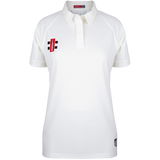 The Gray Nicolls Ladies Matrix V2 Match Shirt is a white, short-sleeved polo with a collar, featuring a small red and black logo on the left chest and tag near the hem. This breathable shirt has a buttonless placket for comfort.