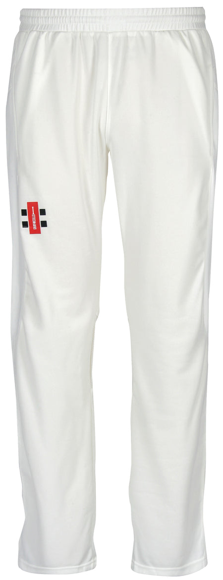 A pair of Gray Nicolls Velocity Cricket Trousers in white, showing a red and black logo on the left thigh, displayed against a plain white background.