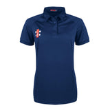 The Gray Nicolls Matrix V2 Ladies Polo Shirt is a navy slim fit, short-sleeve polo with a collar and three buttons. It has a small red and white rectangular logo on the left chest and is shown against a plain white background.