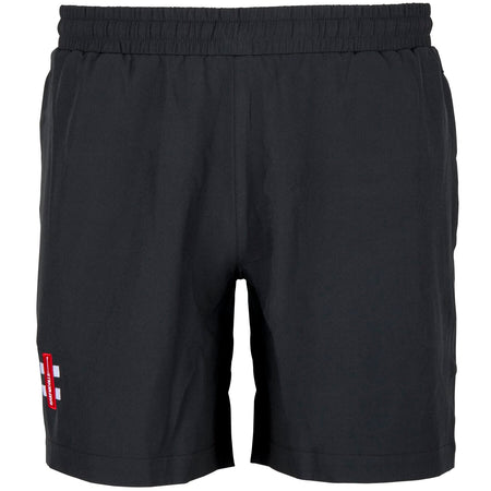 The Gray Nicolls Rockhampton CC Velocity Shorts - Junior are black athletic cricket training shorts with an elastic waistband, side pockets, and a small red and white logo on the lower left leg. Displayed against a plain white background.