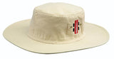 The Gray Nicolls Sun Hat is a cream cotton hat with a flat crown and ventilation eyelets, featuring a red and white rectangular Gray Nicolls tag on the side.